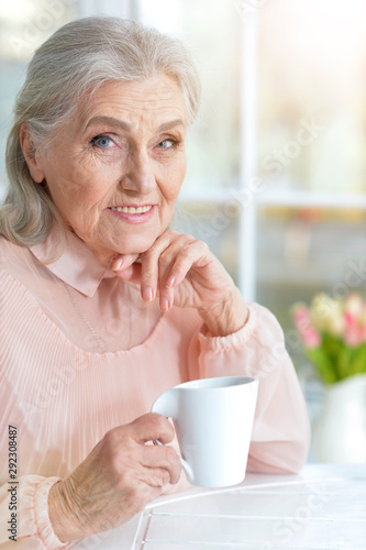 Portrait of beautiful smiling senior woman drinking tea