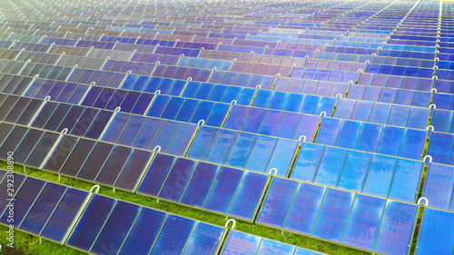 Ariel view , Shot from a drone on a farm field there are a lot of solar panels that produce environmental energy. 