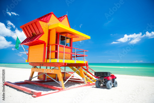 Vibrant sunny view lifeguard tower painted bright colors under blue sky on South Beach, Miami, Florida