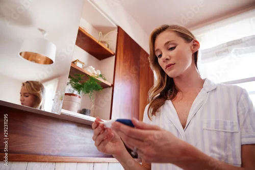 Obraz Woman Looking At Positive Result Pregnancy Test In Bathroom