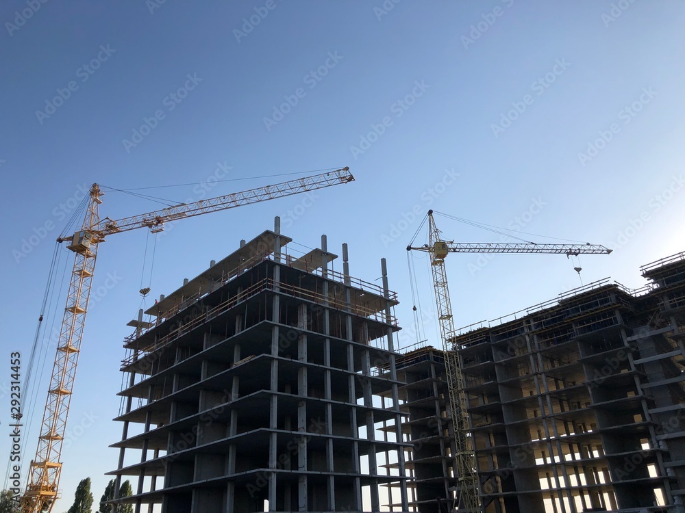 Monolitic building with cranes. New high residental building Monolitic building with cranes. New high residental building