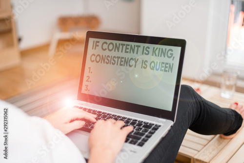 Handwriting text writing If Content Is King Consistency Is Queen. Conceptual photo Marketing strategies Persuasion woman laptop computer office supplies technological devices inside home photo
