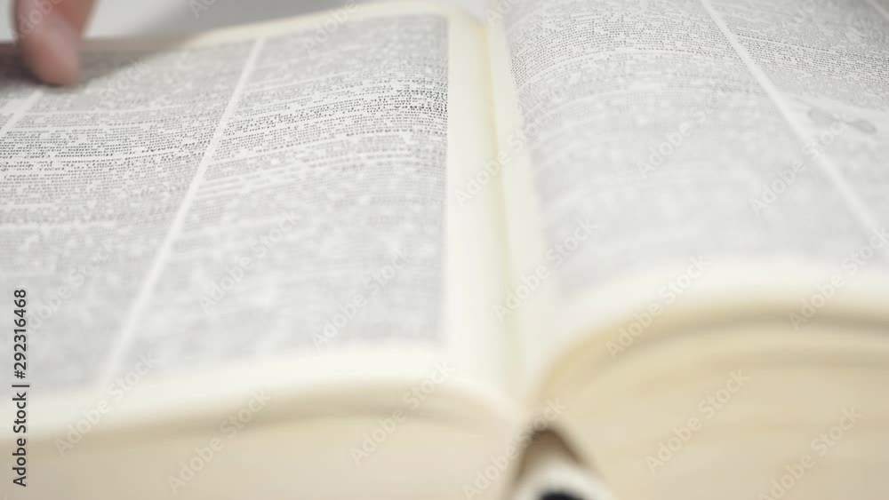 While reading encyclopedia. Close up shot of man's hands turning the pages of a reference book. While reading encyclopedia. Close up shot of man's hands turning the pages of a reference book.