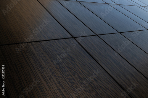 Diagonal view of dark brown venge tile wall surface, wood imitation texture
