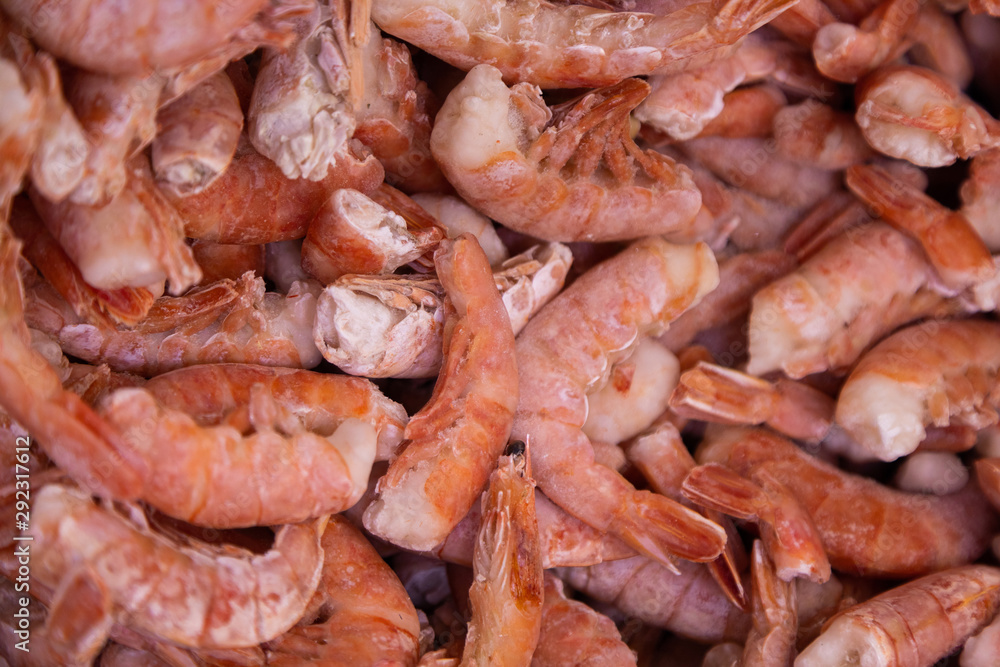 Organic grown shrimps chilled in ice, top view. abstract background and food texture.