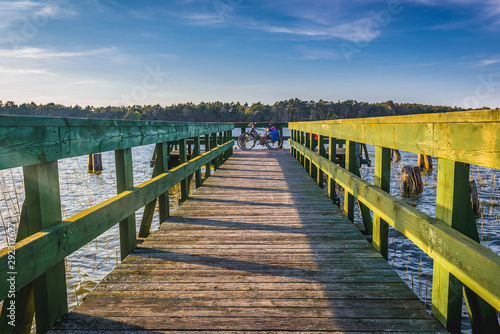 Wooden viewing bridge on Dolgie Wielke Lake in Slowinski National Park in Pomerania region, Poland photo