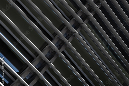 Angular view close-up of dark grey metal beams structure in fragment of building photo