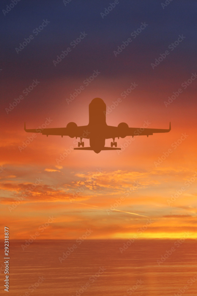 Silhouette of plane in the sky above Sea at Sunset. travel, flight, vacation Concept. Low key photo. relax time