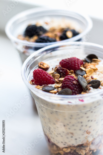 Chia pudding with yogurt, blackberries, raspberries, bananas and oatmeal served in cups