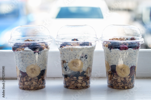 Chia pudding with yogurt, blackberries, raspberries, bananas and oatmeal served in cups