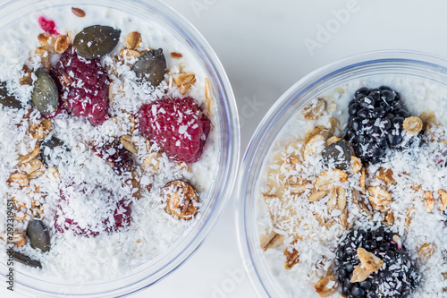 Chia pudding with yogurt, blackberries, raspberries, bananas and oatmeal served in cups