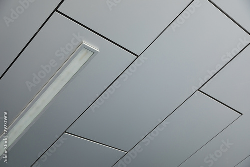 Ceiling covered with smooth white panels with a lamp