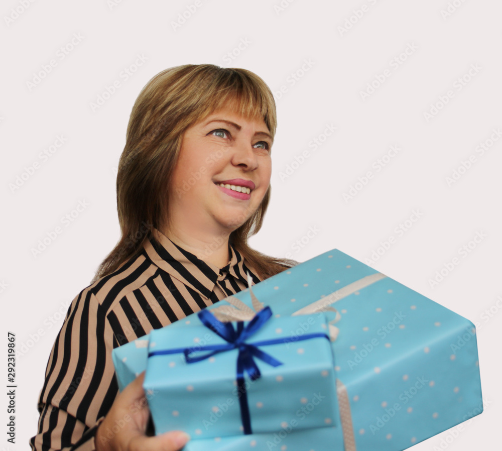 smiling woman holding a gift in blue paper with a ribbon on a light background, concept of Valentine's Day, Christmas presents, mother's day, new year, close-up, copy space smiling woman holding a gift in blue paper with a ribbon on a light background, concept of Valentine's Day, Christmas presents, mother's day, new year, close-up, copy space