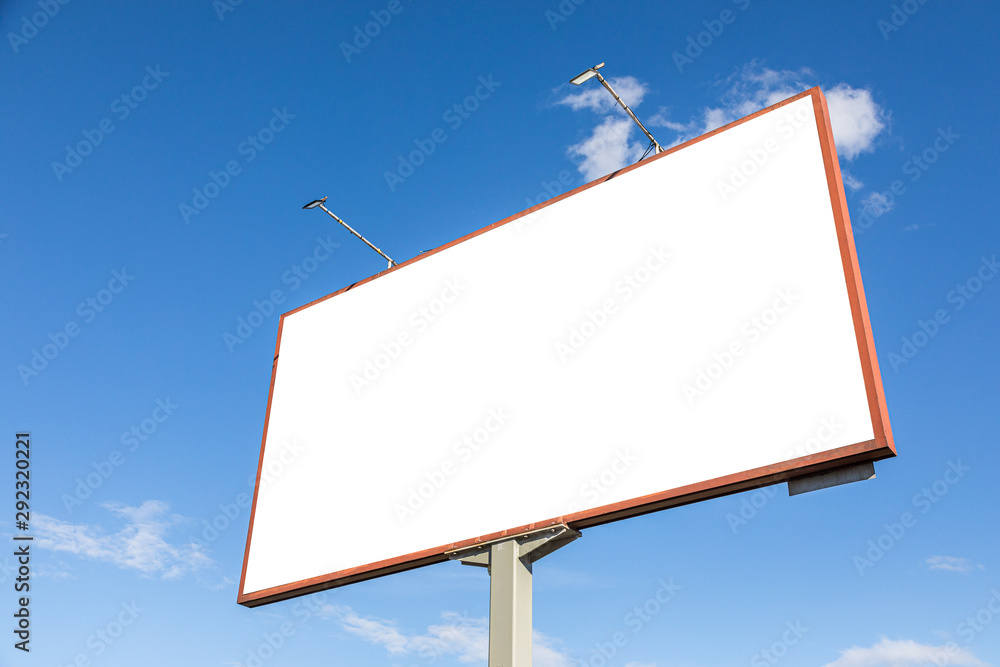 White empty advertisement billboard mockup against blue sky White empty advertisement billboard mockup against blue sky