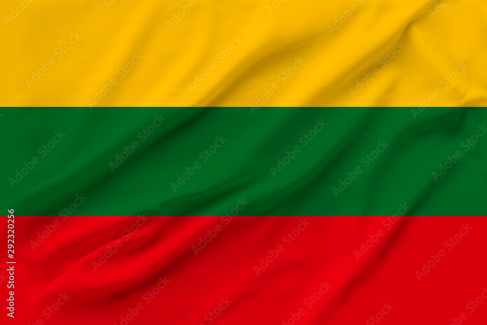 beautiful photo of the national flag of Lithuania on delicate shiny silk with soft draperies, the concept of state power, country life, horizontal, close-up, copy space