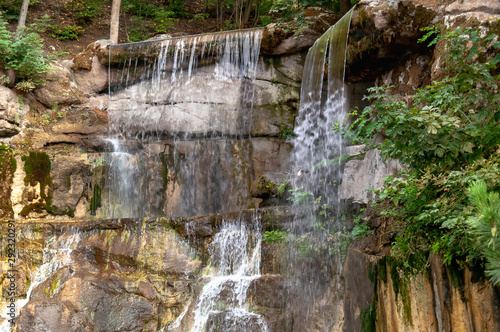 Fototapeta Naklejka Na Ścianę i Meble -  Waterfall in the park close-up. Mountain waterfall.