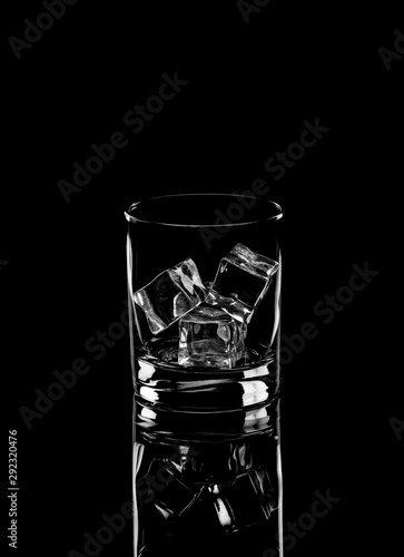 Vodka or gin tonic with ice in rocks glass on black background