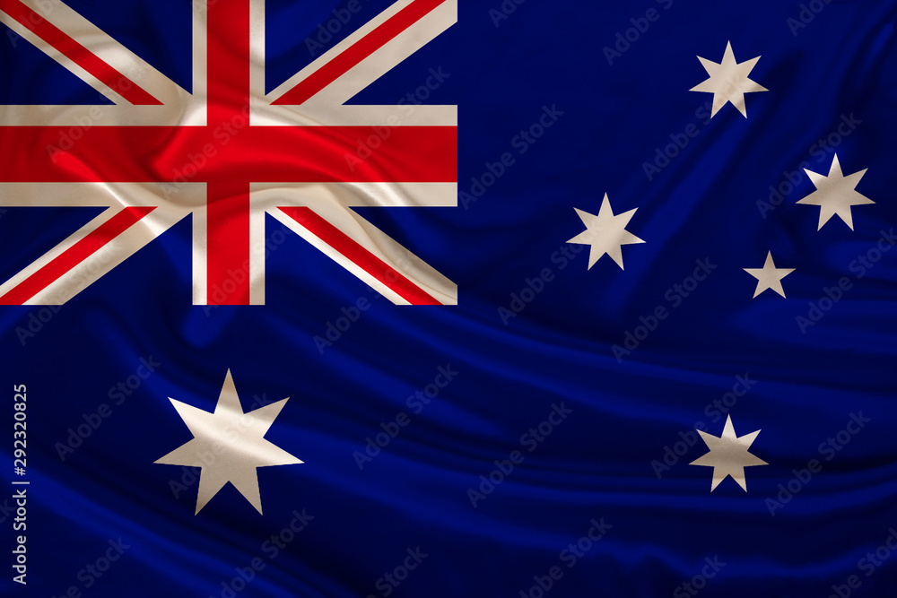 Fototapeta premium photograph of the national flag of Australia on a luxurious texture of satin, silk with waves, folds and highlights, closeup, copy space, travel concept, economy and state policy, illustration
