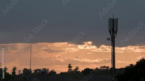 Isolated silhouette Phone Mast on a cloudy day during sunset