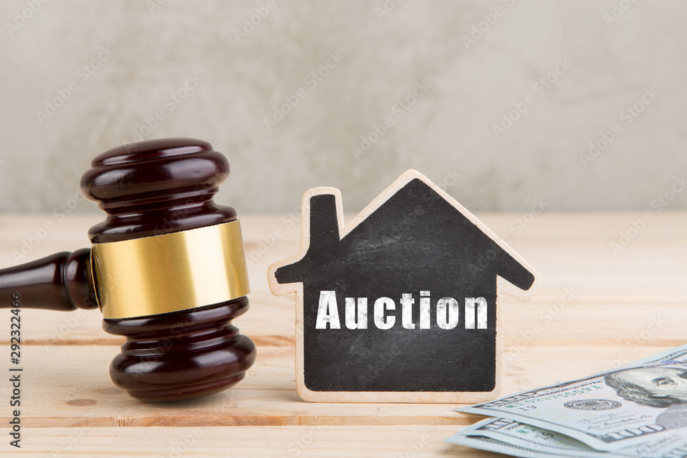 Real estate concept auction gavel and little house with inscription Auction
