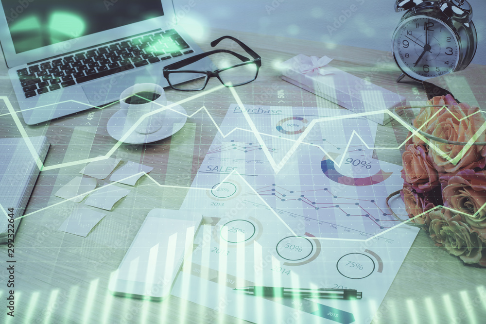 Stock market chart hologram drawn on personal computer background. Multi exposure. Concept of investment. Stock market chart hologram drawn on personal computer background. Multi exposure. Concept of investment.