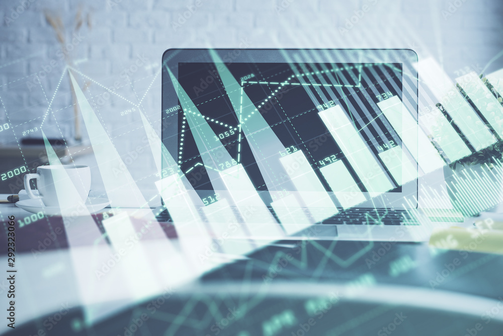 Forex Chart hologram on table with computer background. Double exposure. Concept of financial markets. Forex Chart hologram on table with computer background. Double exposure. Concept of financial markets.