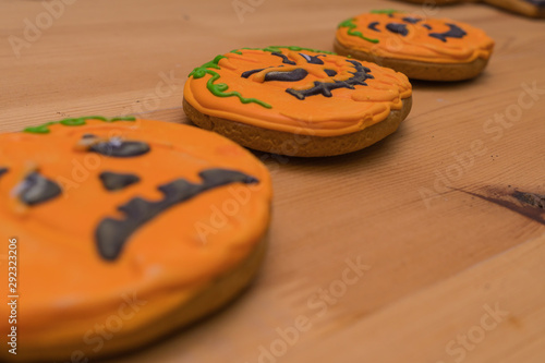 Halloween cookies in the form of emotional pumpkin faces. Close-up from the side