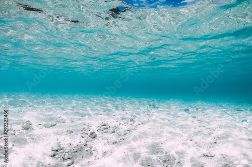 Blue ocean with white sand bottom underwater in Hawaii
