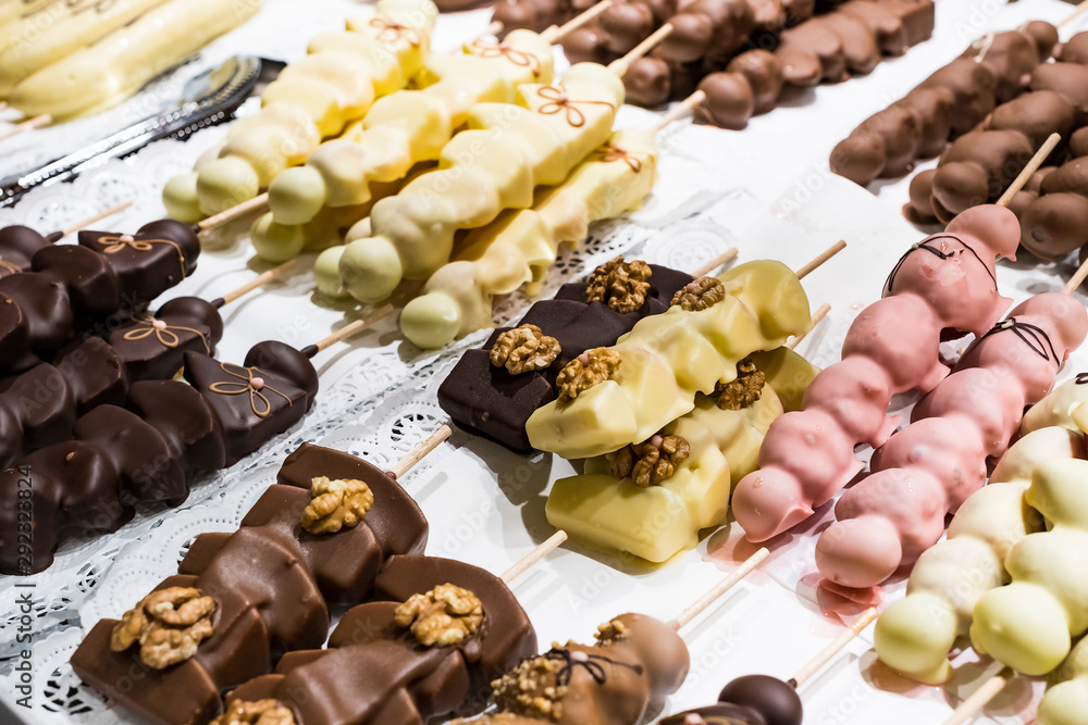 Fruits bananas, strawberries, nuts, apples, peaches drenched in white and dark chocolate. Fruits bananas, strawberries, nuts, apples, peaches drenched in white and dark chocolate.