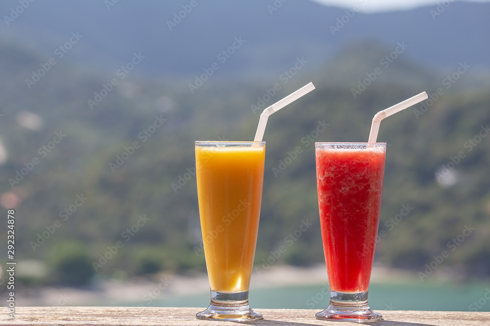 Two fresh organic shake from mango and watermelon in thai restaurant on the beach near sea in Thailand. Close up Two fresh organic shake from mango and watermelon in thai restaurant on the beach near sea in Thailand. Close up