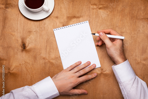 Planning 2020 in a notebook with men's hands