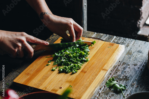 Woman hands chopping parsley