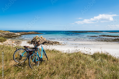 Bicycle parked against the sea in the island of Batz photo