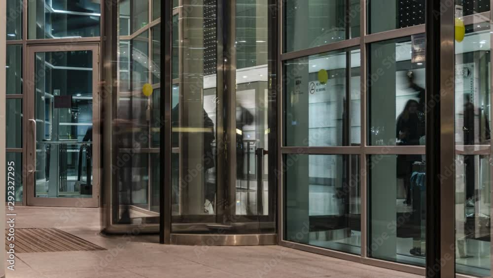  The flow of people passing through the revolving door of the modern office building at the end of the working day,time lapse