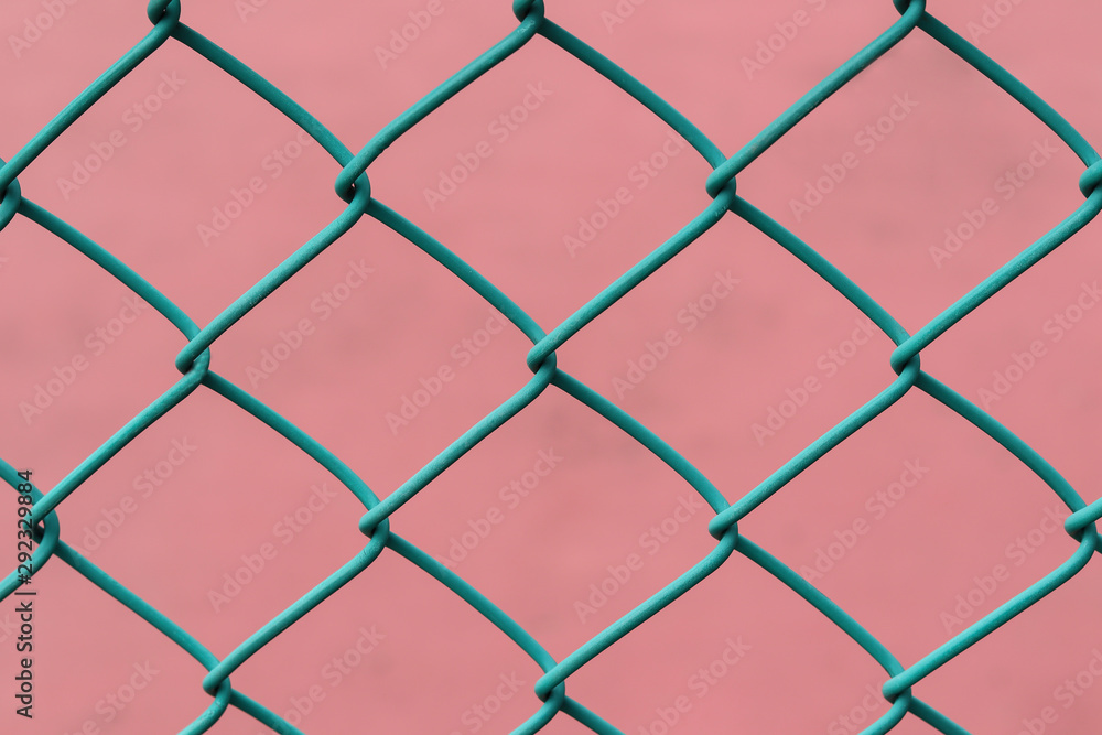 Fototapeta premium Chain Link Fence with pink Background.