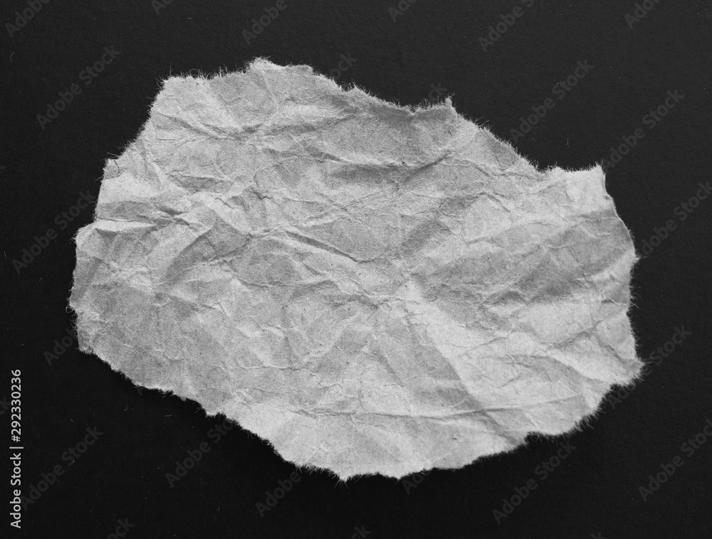 Ripped paper on black background, space for advertising copy. Ripped paper on black background, space for advertising copy.
