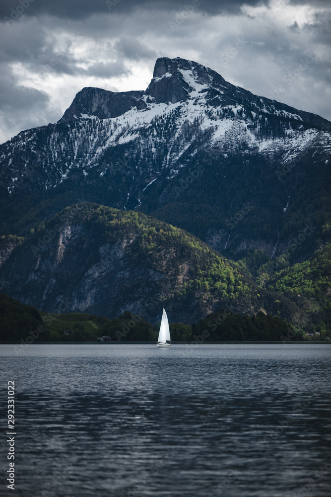 sailboat in the water in front of mountains