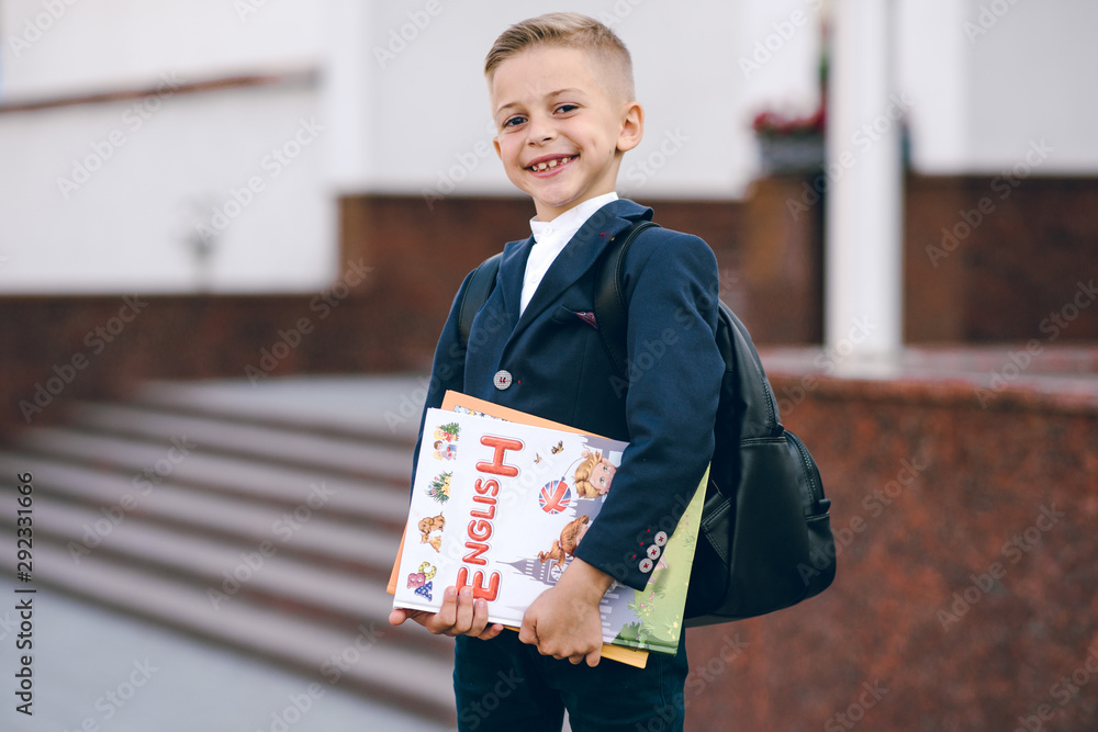 Little schoolboy with books in her hand. Back to school. Little schoolboy with books in her hand. Back to school.