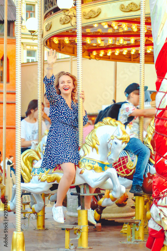 Young pretty woman closeup in different poses on the carousel background near Red square in Moscow