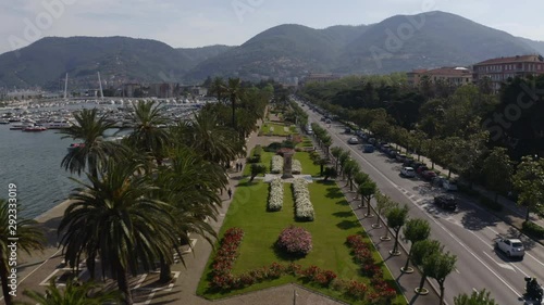 Drone flying over park and busy road near harbor photo