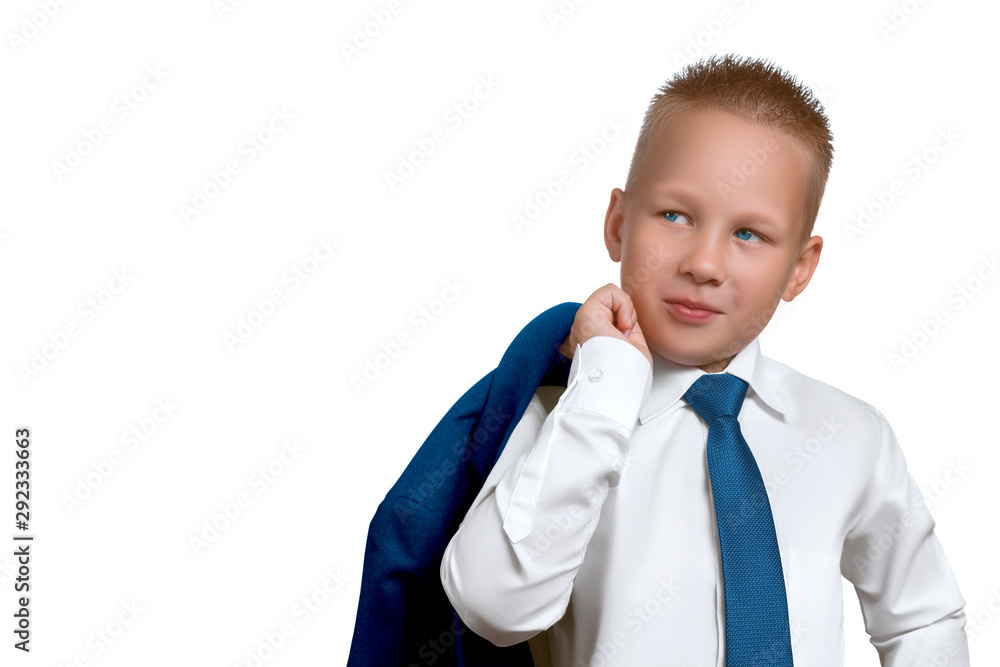 Handsome european boy in the character of a successful businessman or leader in a white shirt with a blue tie and a jacket on his shoulder, looking away from the camera isolated on white background