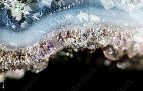 Gemstone Amethyst closeup as a part of cluster geode filled with rock Quartz crystals.