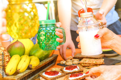 Colorful table with natural food and healthy drinks in hands. Exotic fruits fresh beverage, cereal biscuits and crackers for a healthy and nutritious breakfast. Vegan vegetarian bio diet meal concept photo