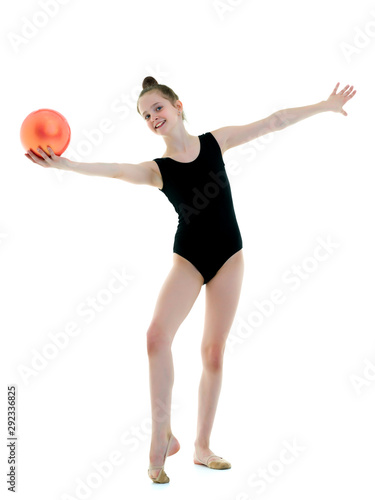 Girl gymnast performs exercises with the ball.