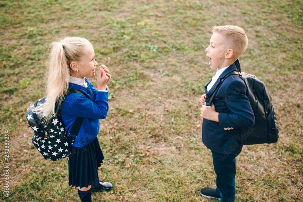 Young students, boy and girl, going to school. Two school kids with ...