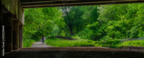 woman standing on bridge over lock