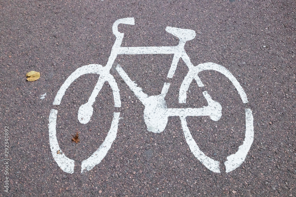 White picture bike on the bicycle path. Bicycle road sign on asphalt. White picture bike on the bicycle path. Bicycle road sign on asphalt.