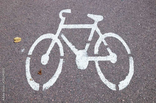 White picture bike on the bicycle path. Bicycle road sign on asphalt.