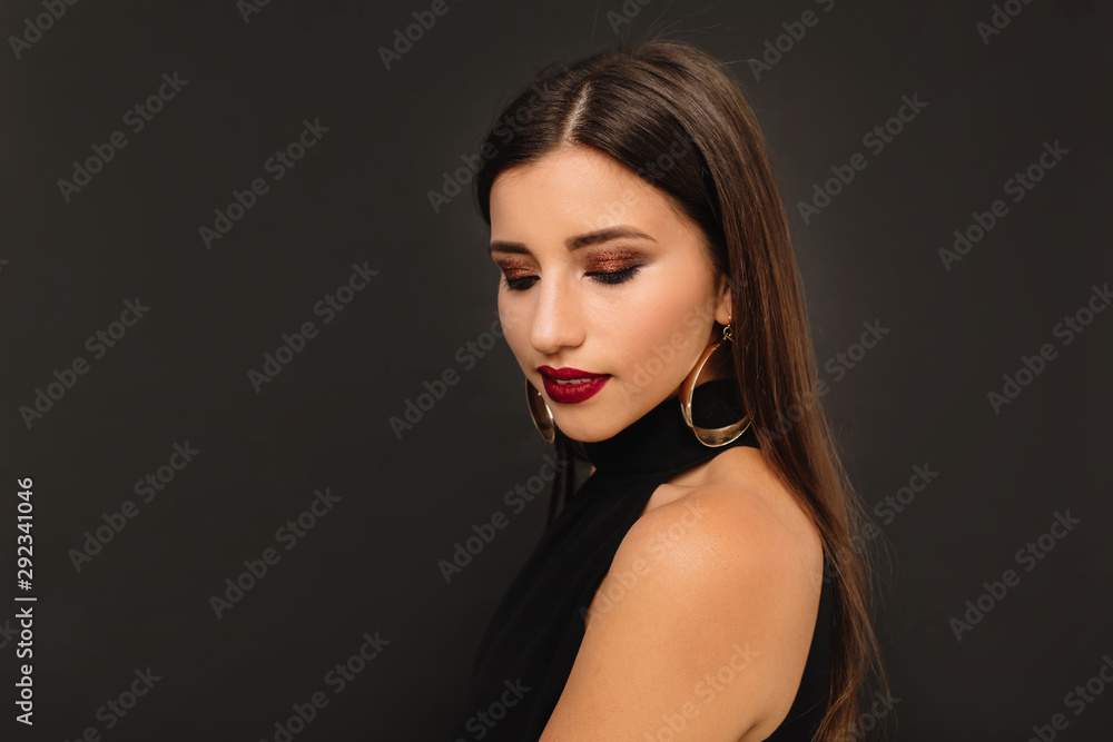 Close up portrait of european fashionable woman with long hair and bright make up over black background Close up portrait of european fashionable woman with long hair and bright make up over black background