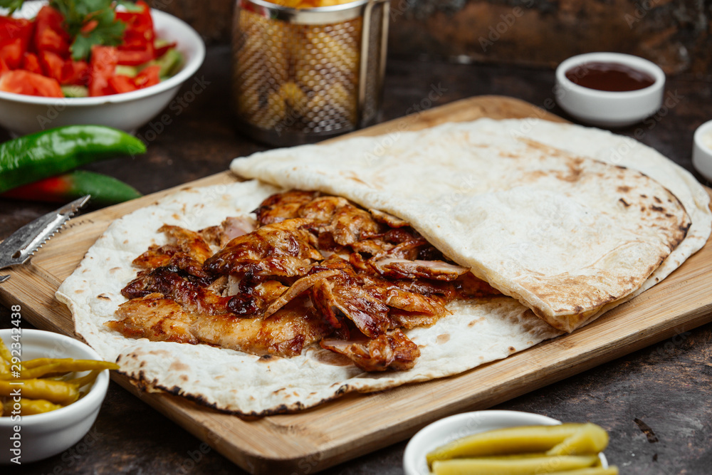 Chicken kebab slices served in the lavash wrap Chicken kebab slices served in the lavash wrap